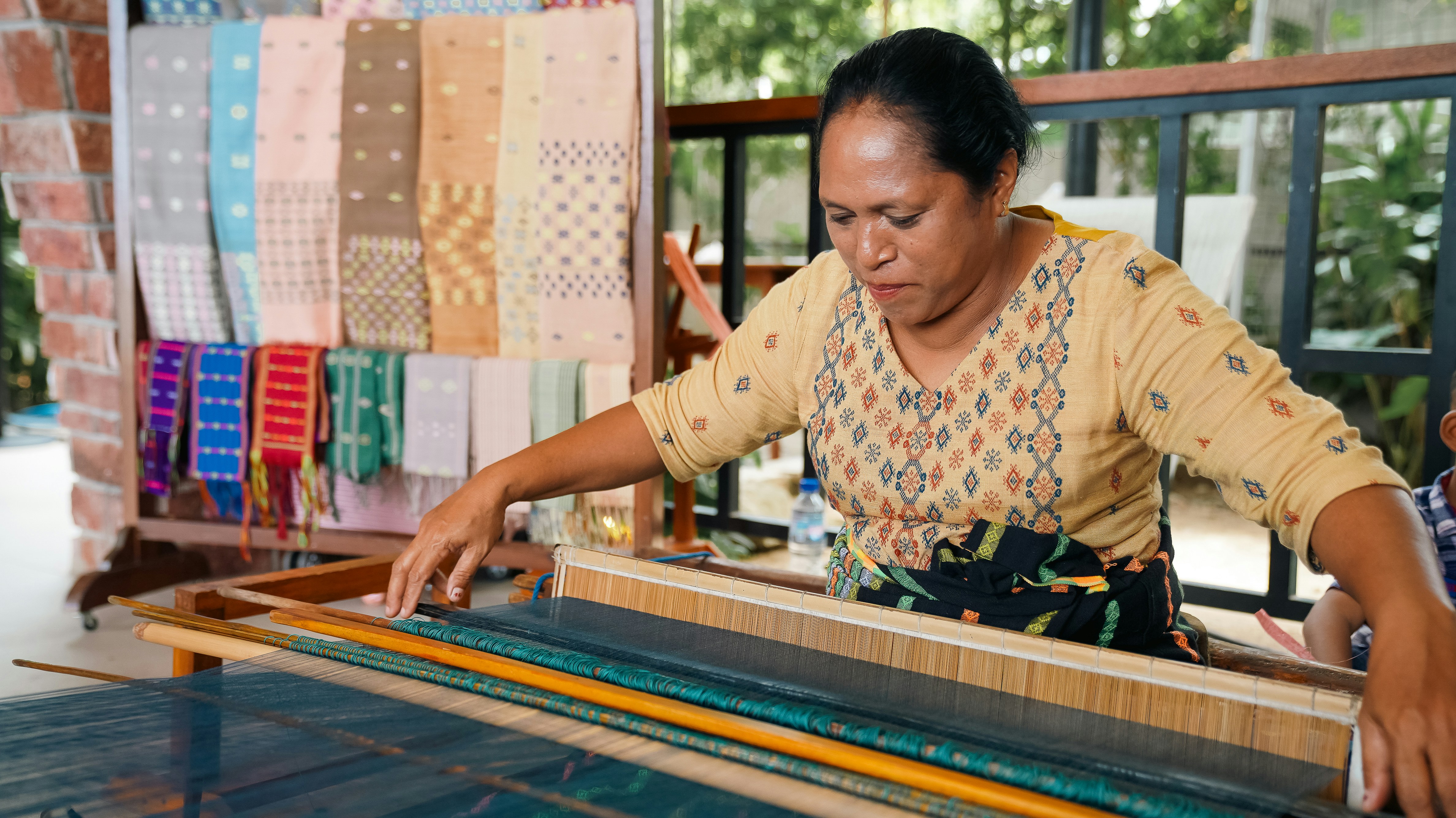 Indonesian woman weaving traditional textile