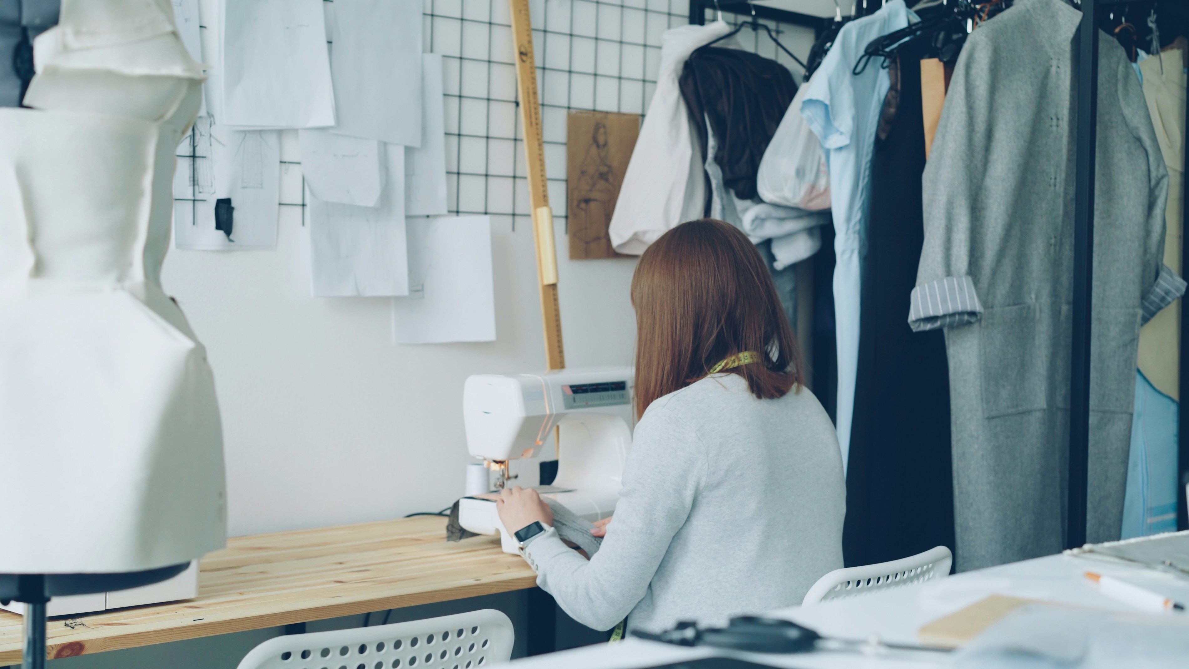 Designer working at a sewing machine in an atelier